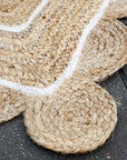 Detailed shot of the edge of a Natural Jute Rug with Scallop Edge.