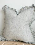 Linen pinstripe ruffle cushion with frayed edge.