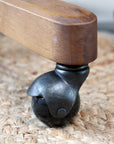 Close up of wheel on natural rattan wooden office chair.