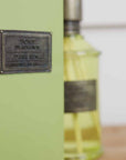 Home fragrance dark rum and lime green reed diffuser presentation box close up