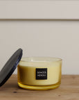 Sences Neroli Lidded Candle with lid rested on the side on wooden console.