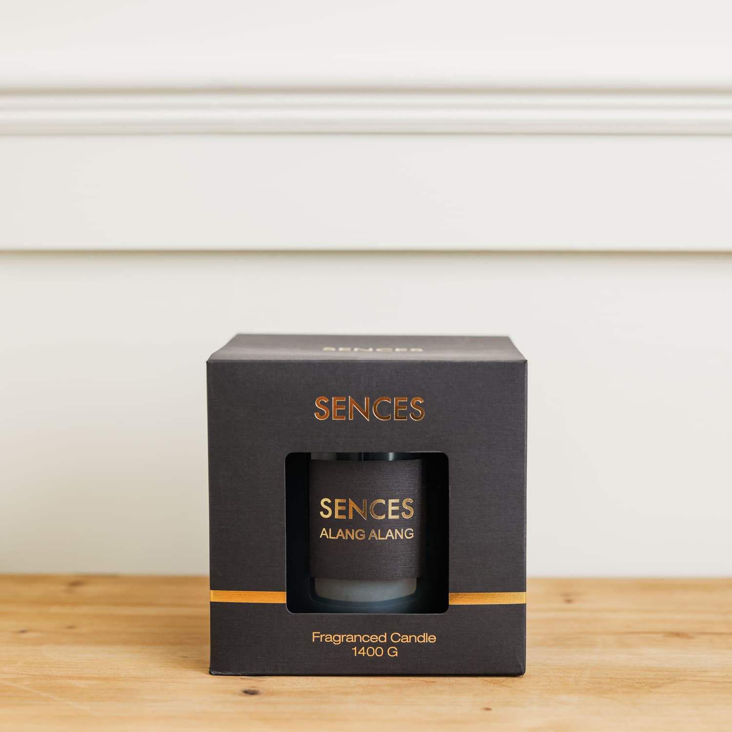 Sences Alang Alang Onyx Candle in black presentation box on wooden console. 