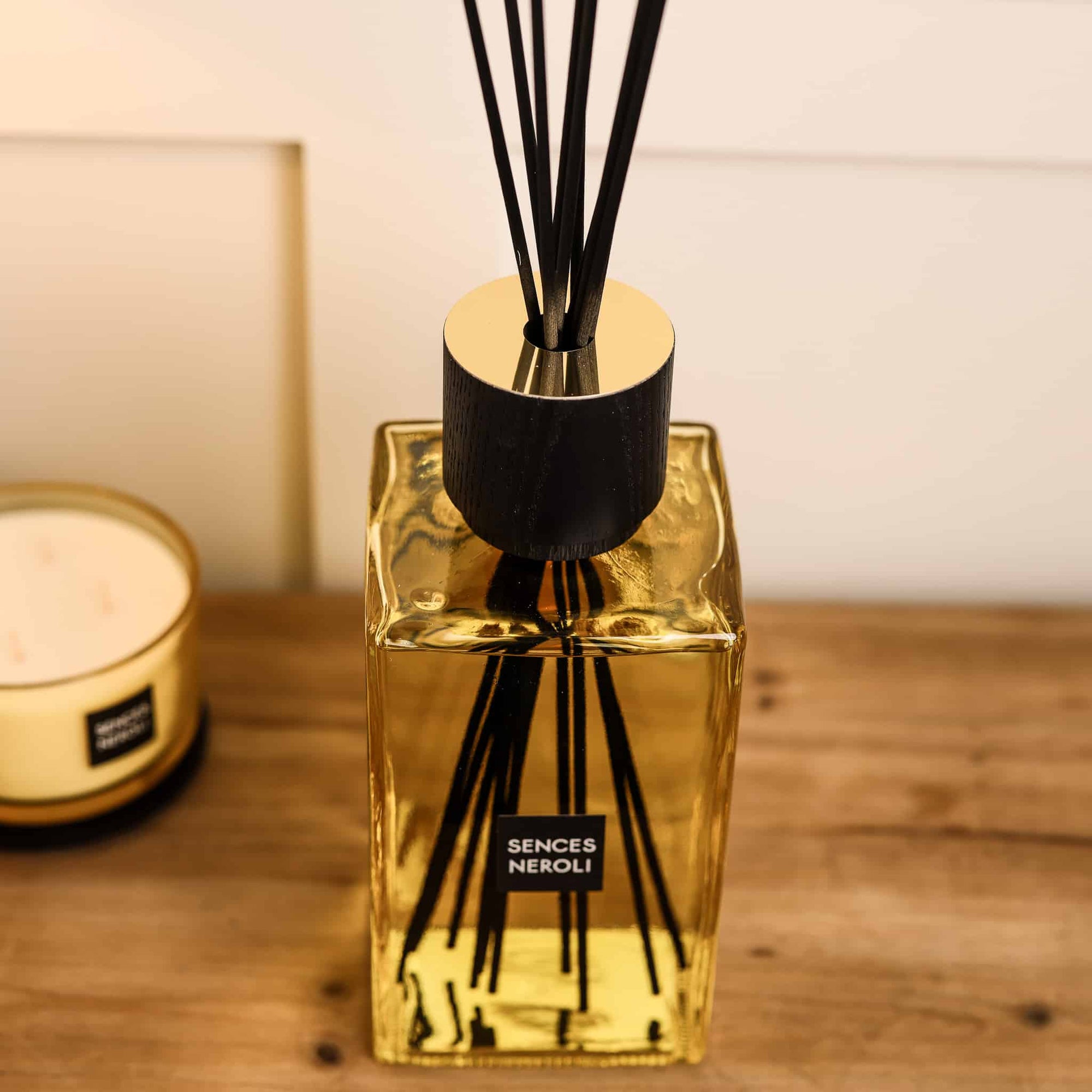 Sences Neroli Extra Large Reed Diffuser close up view of the reeds and neck on wooden console table.