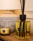 Sences Neroli Extra Large Reed Diffuser on wooden console table styled with lamp and candle.