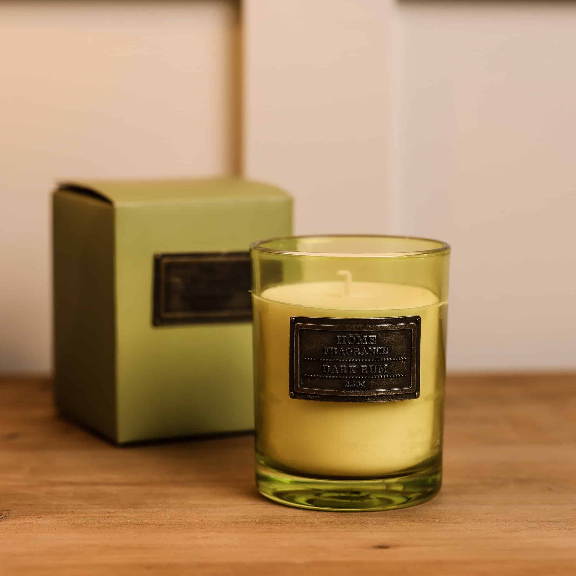 Dark Rum and Lime Candle with presentation box on wooden console. 