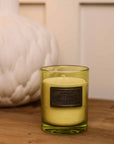 Dark Rum and Lime Candle on wooden console styled with white vase.