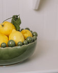 ceramic green bobble bowl with lemons.