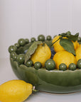 ceramic green bobble bowl with lemons.