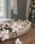 Cream oval bobble bowl with magnolia flowers.