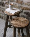 Pair of reclaimed wooden stools with book and cup of tea.