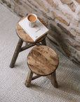 Pair of reclaimed wooden stools with book and cup of tea.