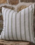 Olive and off white striped cushion on wooden stool.