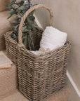 Wicker Stair Basket filled with flowers and a blanket.