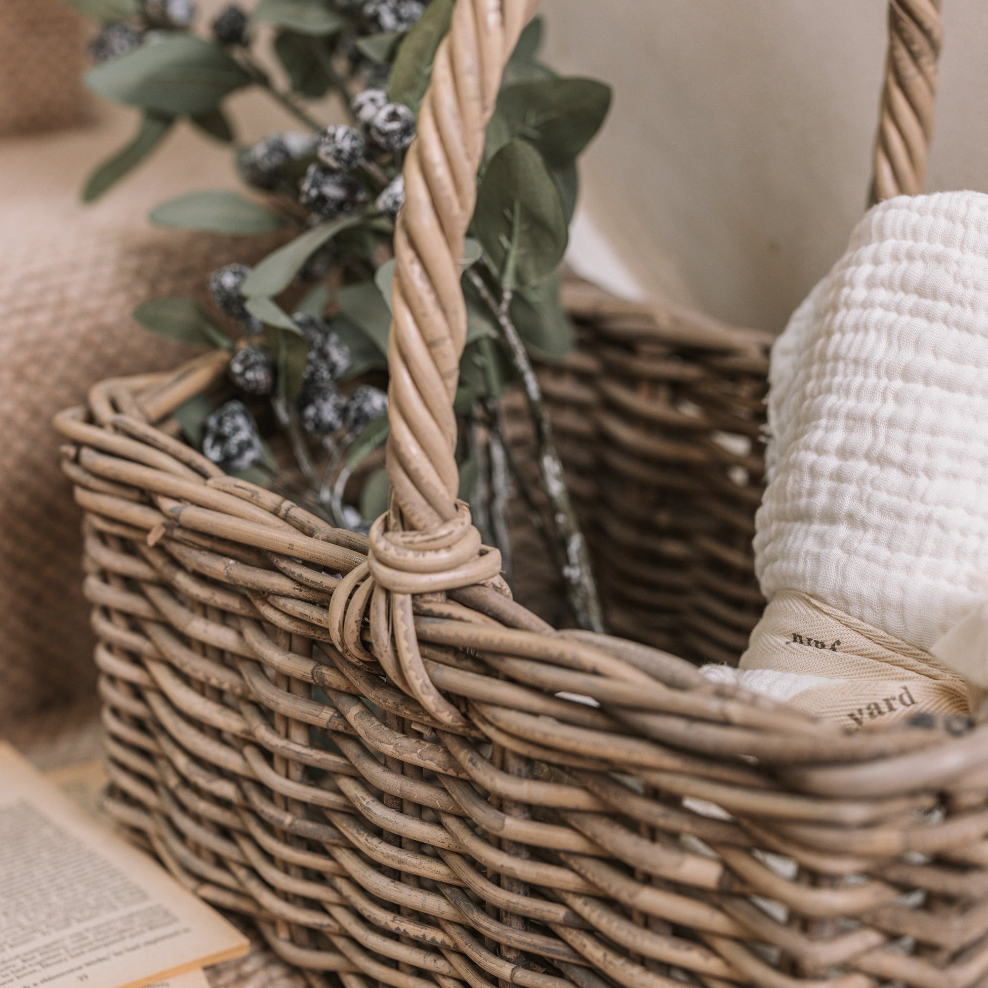 Wicker Stair Basket filled with flowers and a blanket.