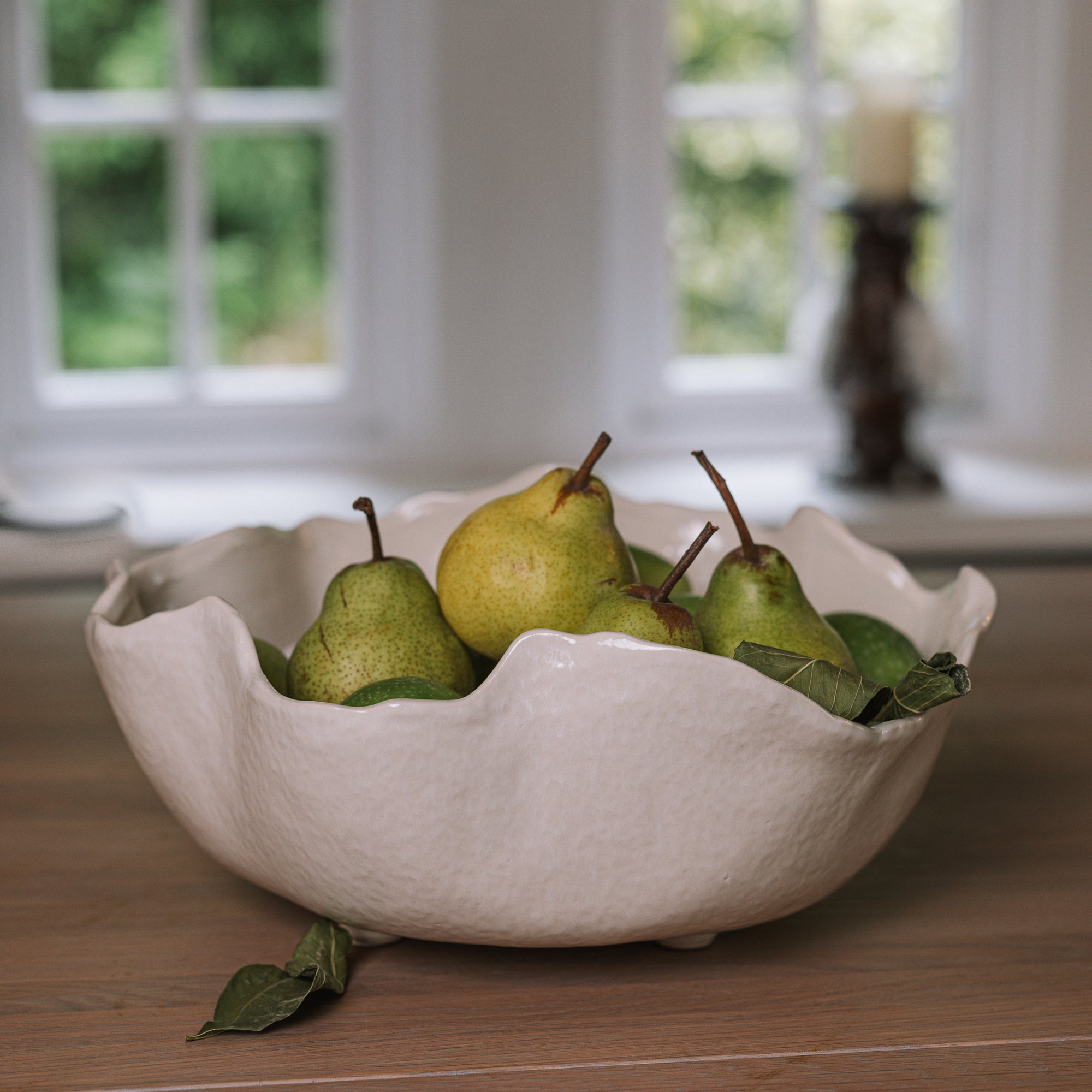 Wavy Ceramic Bowl filled with pears and leaves.