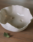 Wavy Ceramic Bowl filled with pears and leaves.