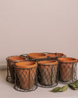 Clay herb pots in basket.