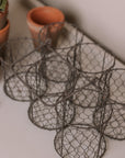 Clay herb pots in wire basket.