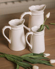 Ceramic jug set of 3 with scalloped edges and handles and tulips.