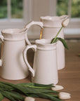 Ceramic jug set of 3 with scalloped edges and handles and tulips.