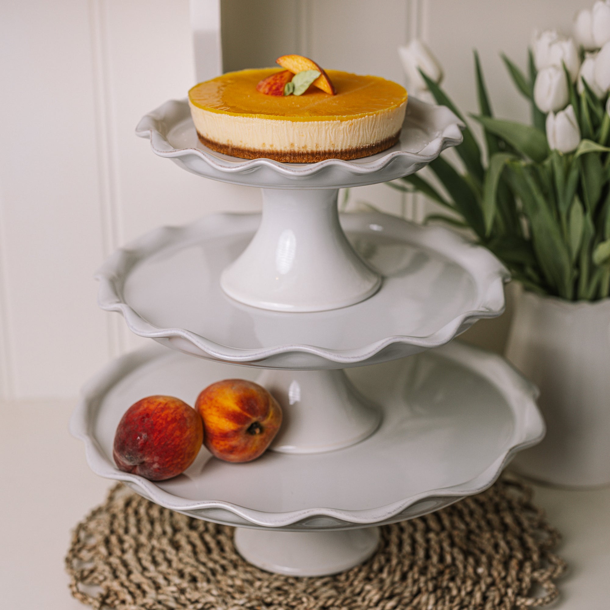 assorted white ceramic cake stands with pie crust edge.