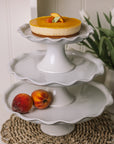assorted white ceramic cake stands with pie crust edge.