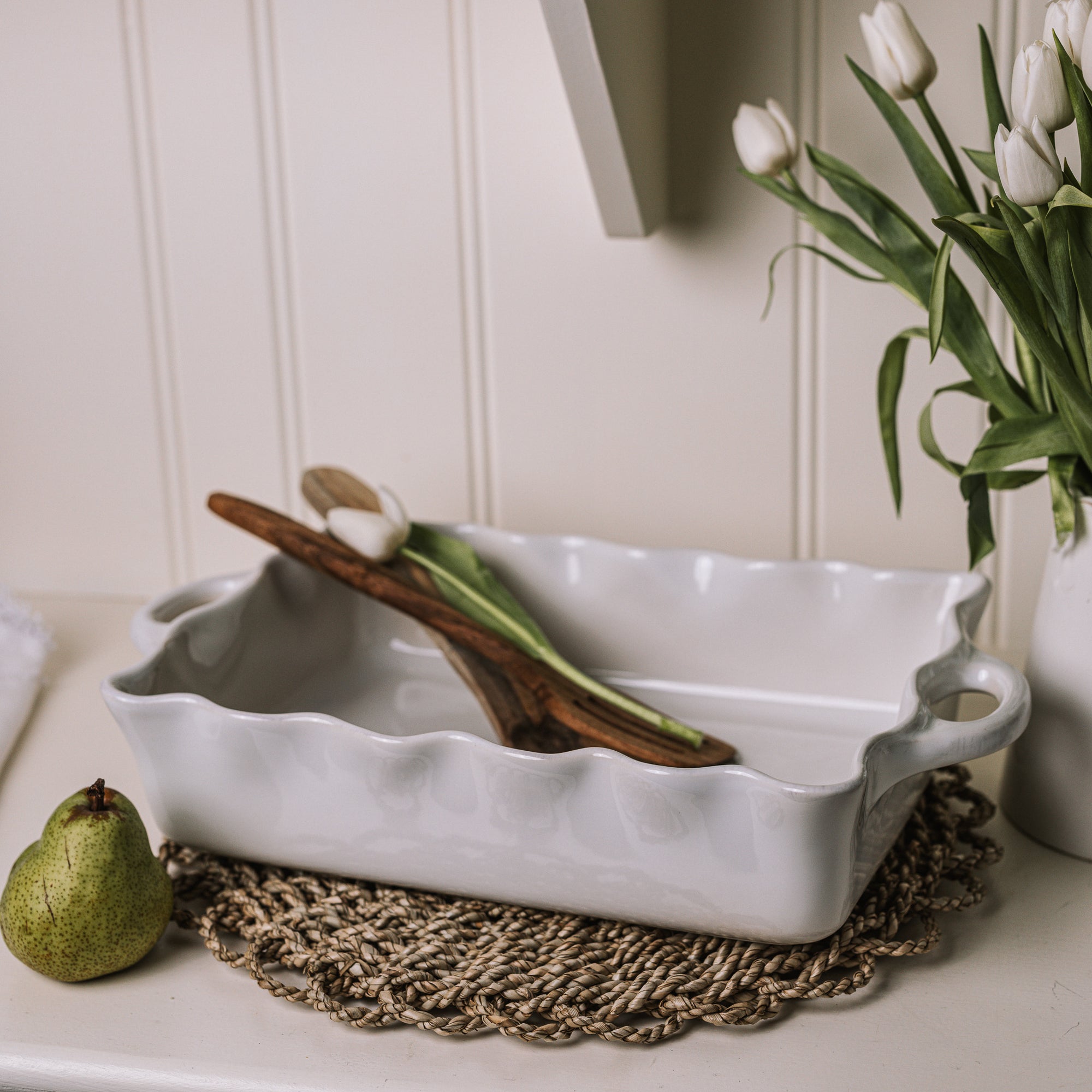 Large white baking dishes with handles and pie crust edge.