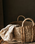 A detailed shot of the large audrey oval seagrass basket with plaited detail on handles.