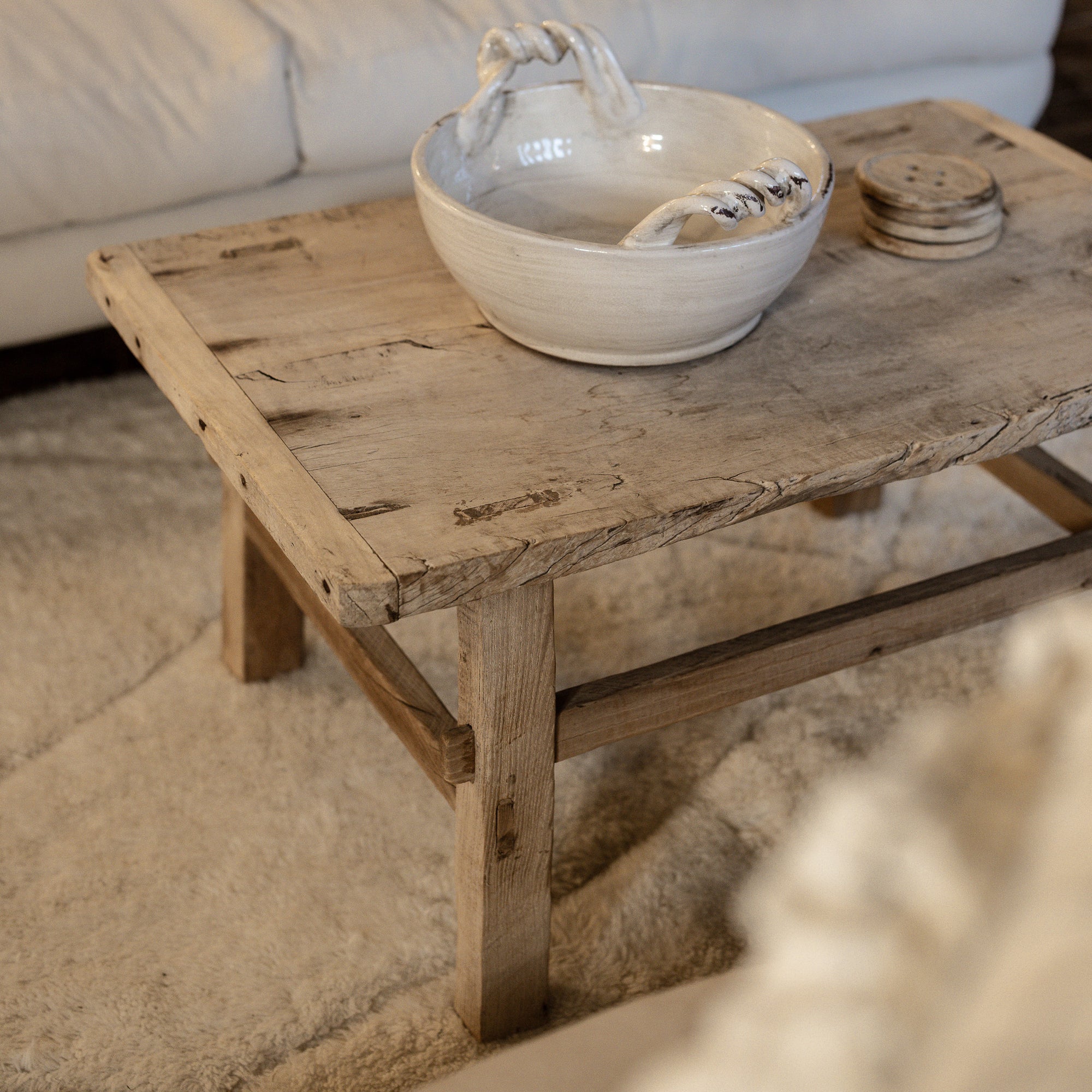 A Reclaimed Wood Coffee Table with ceramic bowl.