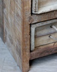 Close up of patina wood on rustic chest of drawers.