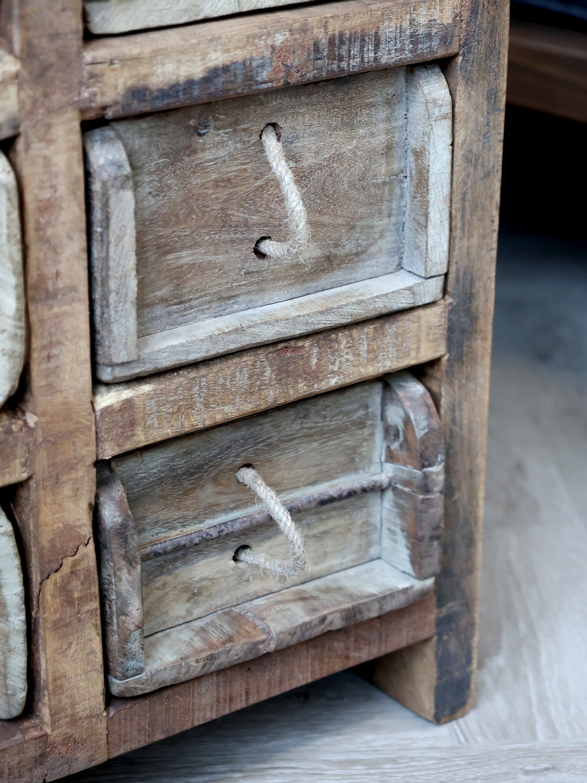 Close up of brick mould drawers on rustic chest of drawers.