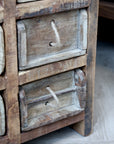 Close up of brick mould drawers on rustic chest of drawers.