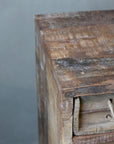 Close up of top surface on rustic chest of drawers.