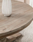 Close up of grain on pine round dining table, with white vase on top.