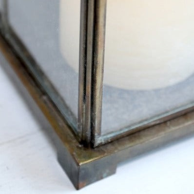 Close up of brass panelling on candle lantern.