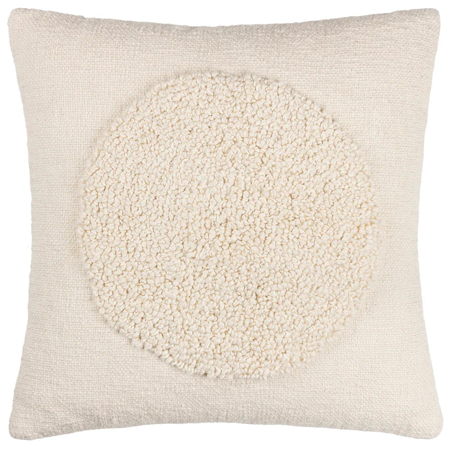 Square cream cushion with circle in middle.