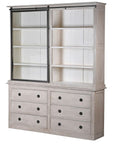 6 drawer white washed storage cabinet with iron hardware and glass sliding door, slid to the left.