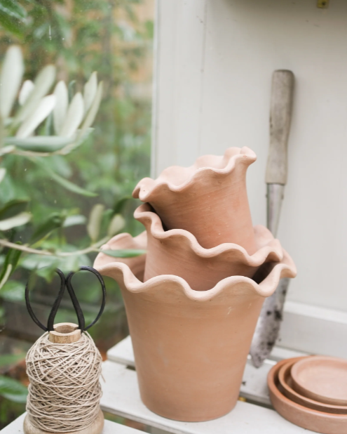 Frilly terracotta plant pot set stacked up in 3.