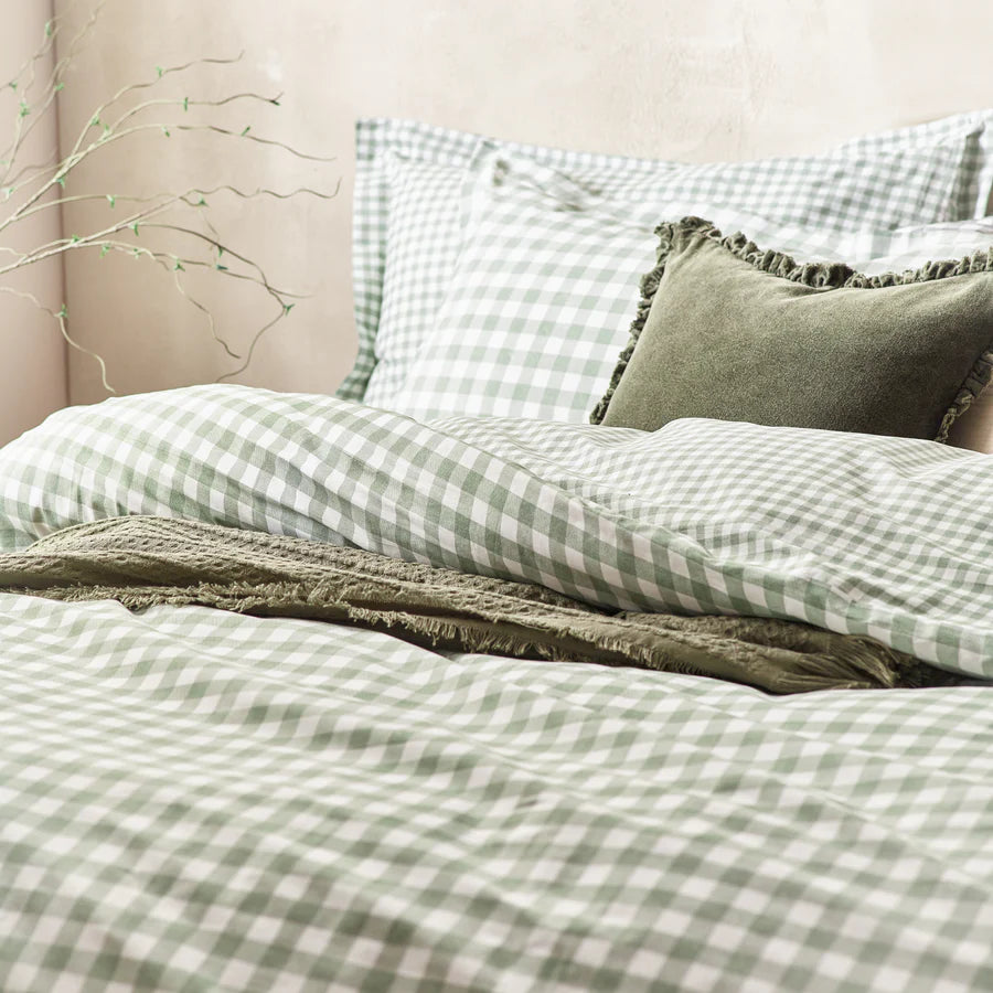 Forest green gingham bedding set on bed with throw and cushions.