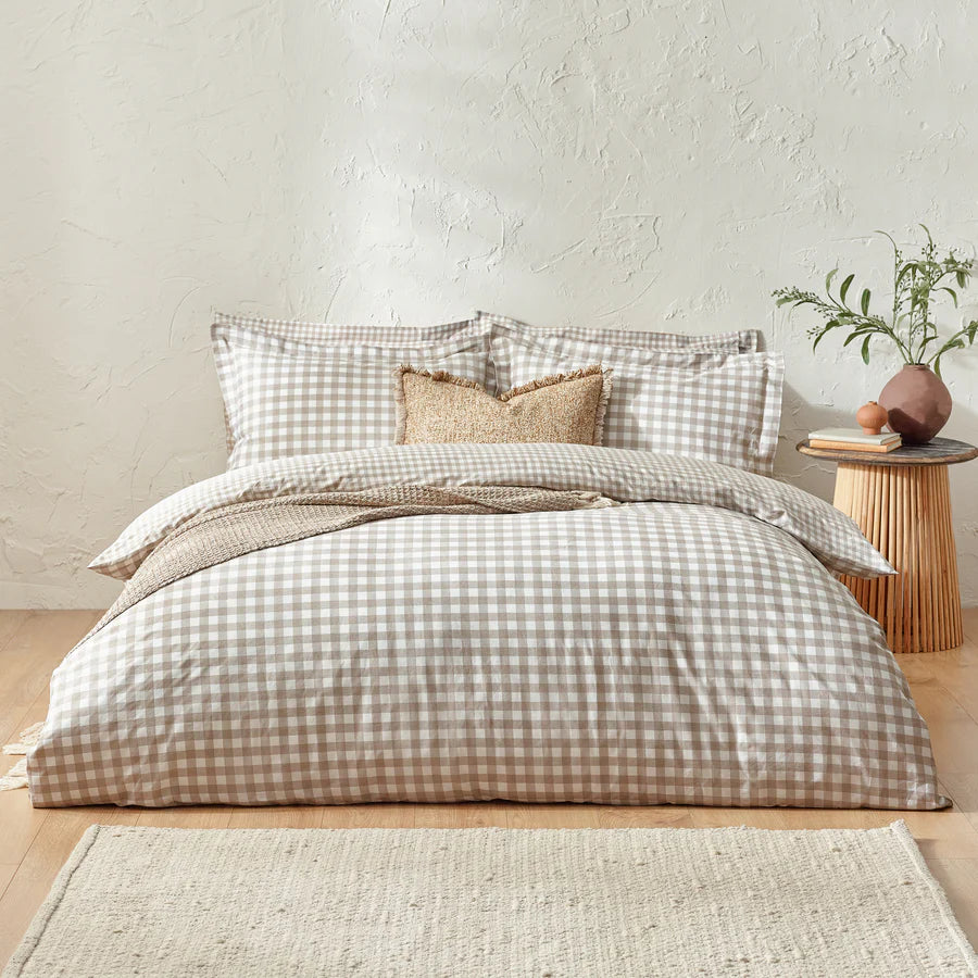 Natural gingham bedding set on bed with cushion and throw.