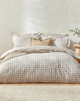 Natural gingham bedding set on bed with cushion and throw.