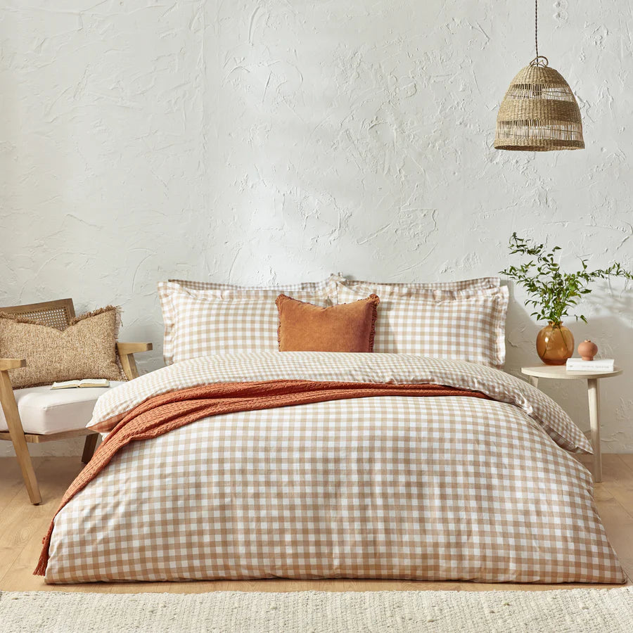 Ginger biscuit gingham bedding set on bed with cushion and throw.