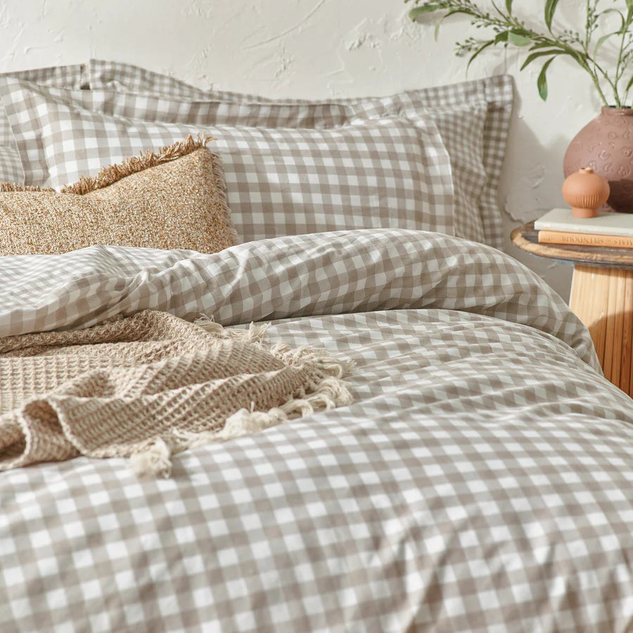 Natural gingham bedding set on bed with cushion and throw.