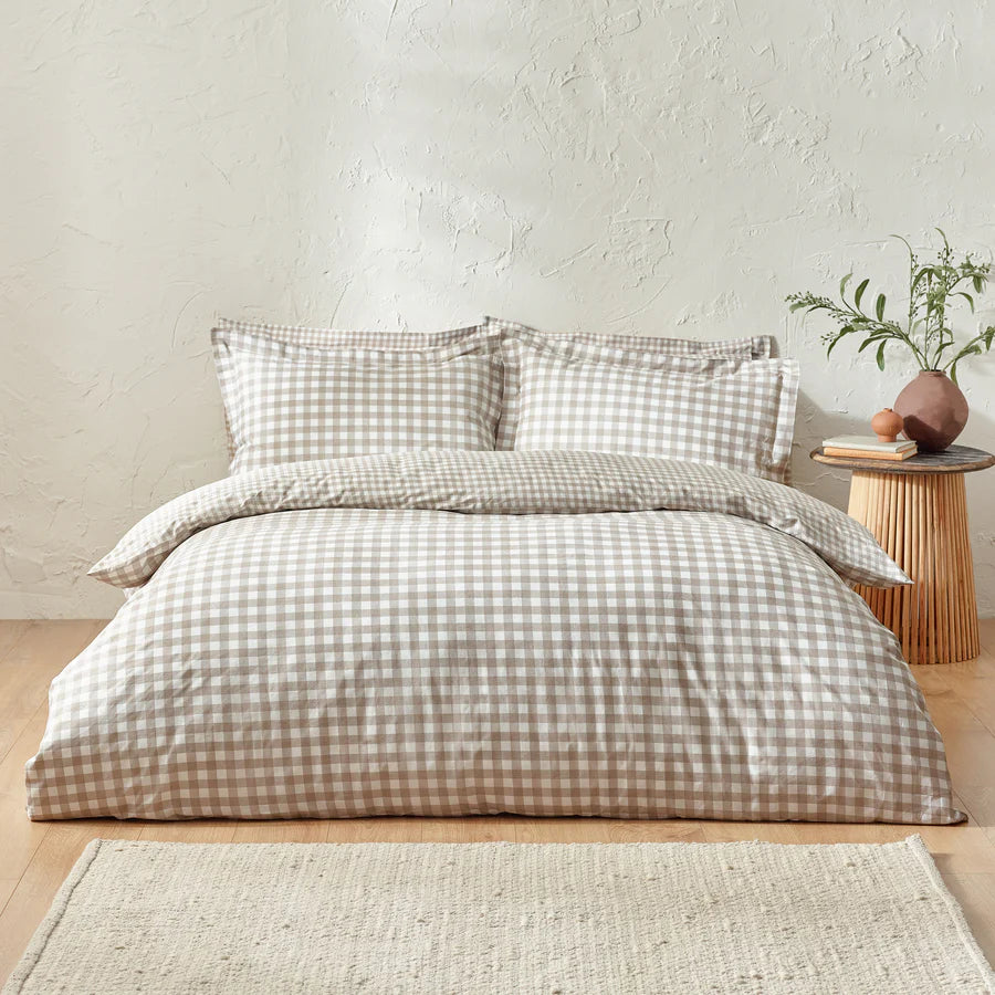 Natural gingham bedding set on bed.