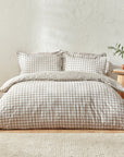 Natural gingham bedding set on bed.