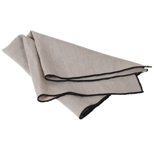 Natural linen napkin with black edge folded over.
