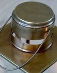 Close up of top and handle of brass and glass candle lantern.