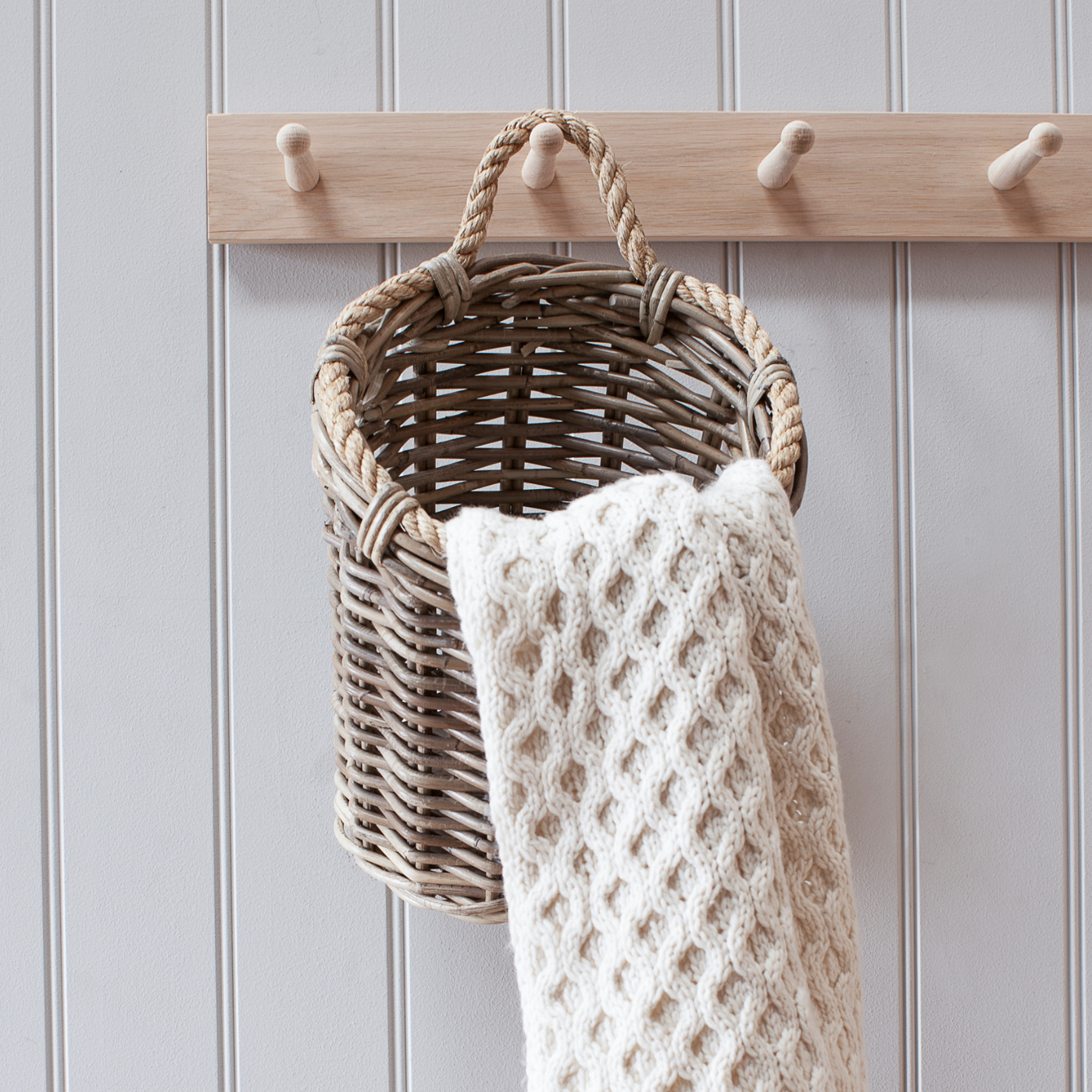 Barnaby Wall Basket with cream knitted blanket.