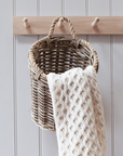 Barnaby Wall Basket with cream knitted blanket.