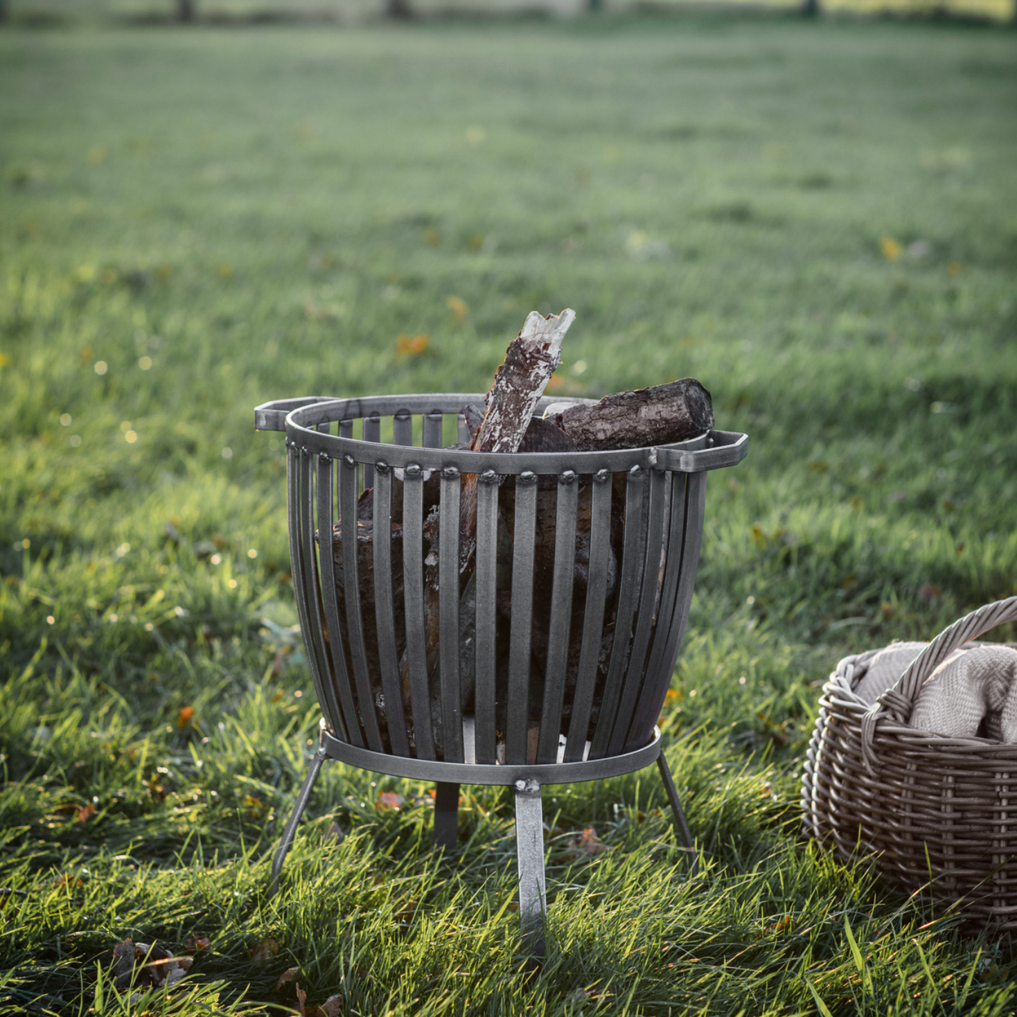 rustic fire put basket in field.